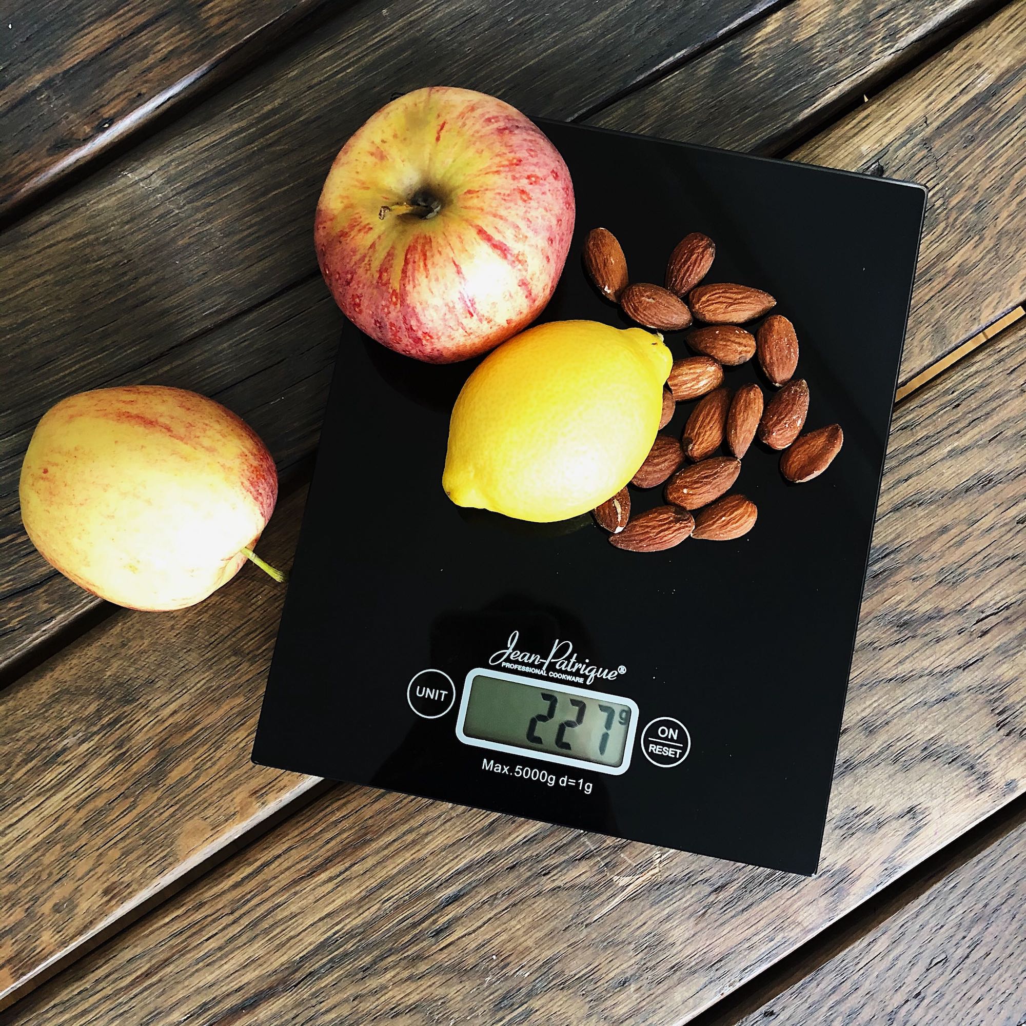 Weighing an Apple Fruit on a Digital Kitchen Scale in Grams on